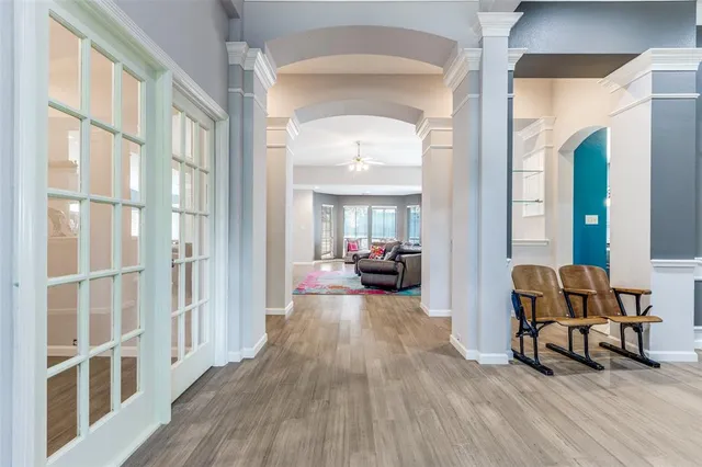 a living room with furniture and a wooden floor