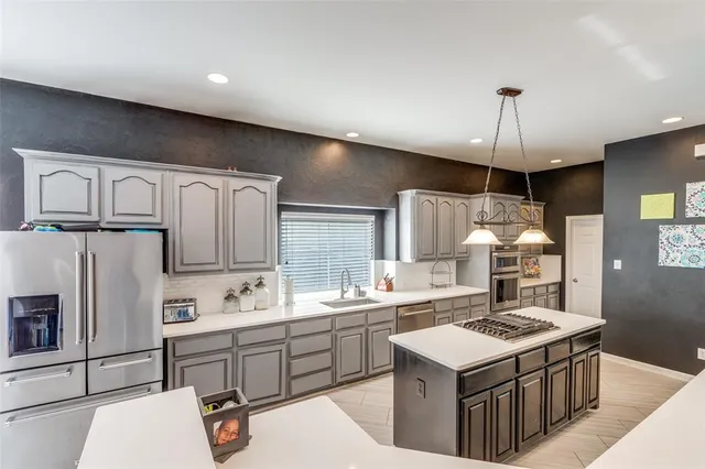 a kitchen with a stove a sink and a refrigerator