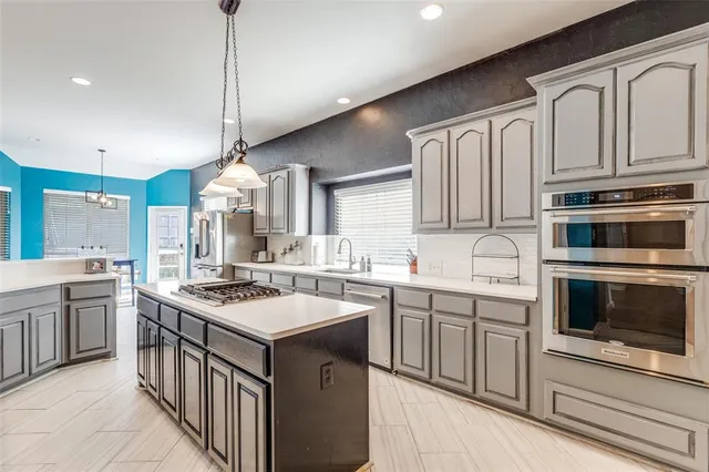 a kitchen with stainless steel appliances granite countertop a stove sink and cabinets