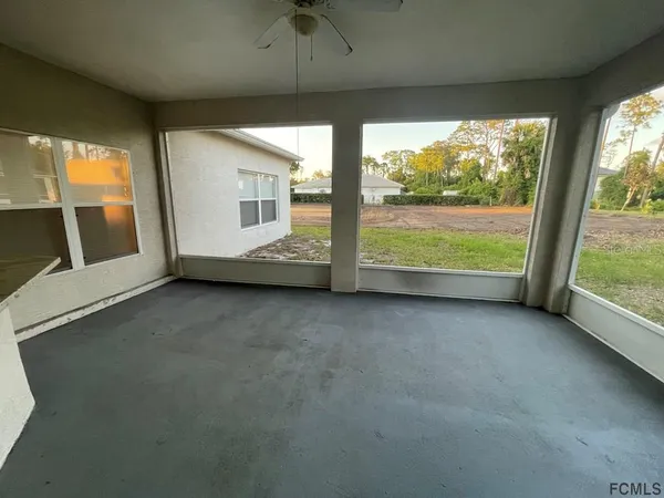 a view of an empty room with large windows