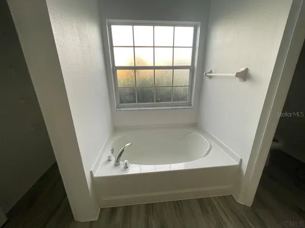 a bathroom with a bathtub and window