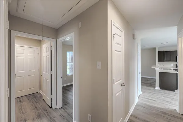 a view of entryway with kitchen and wooden floor