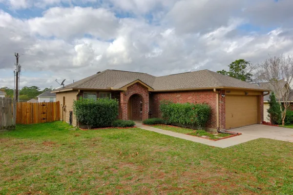 a front view of a house with yard and garage