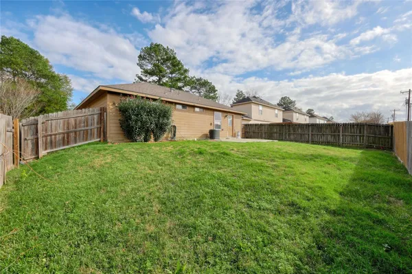 a view of a house with a yard and table
