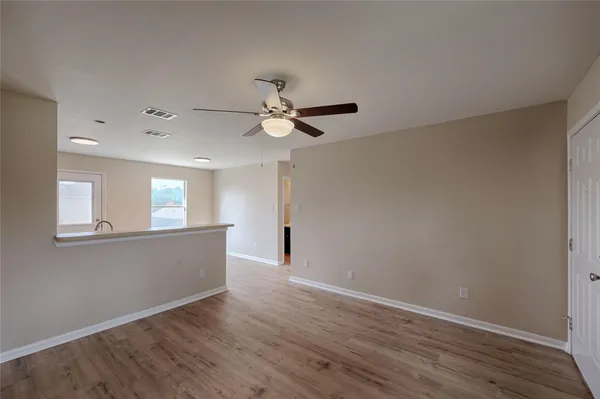 a view of livingroom with hardwood floor and a ceiling fan