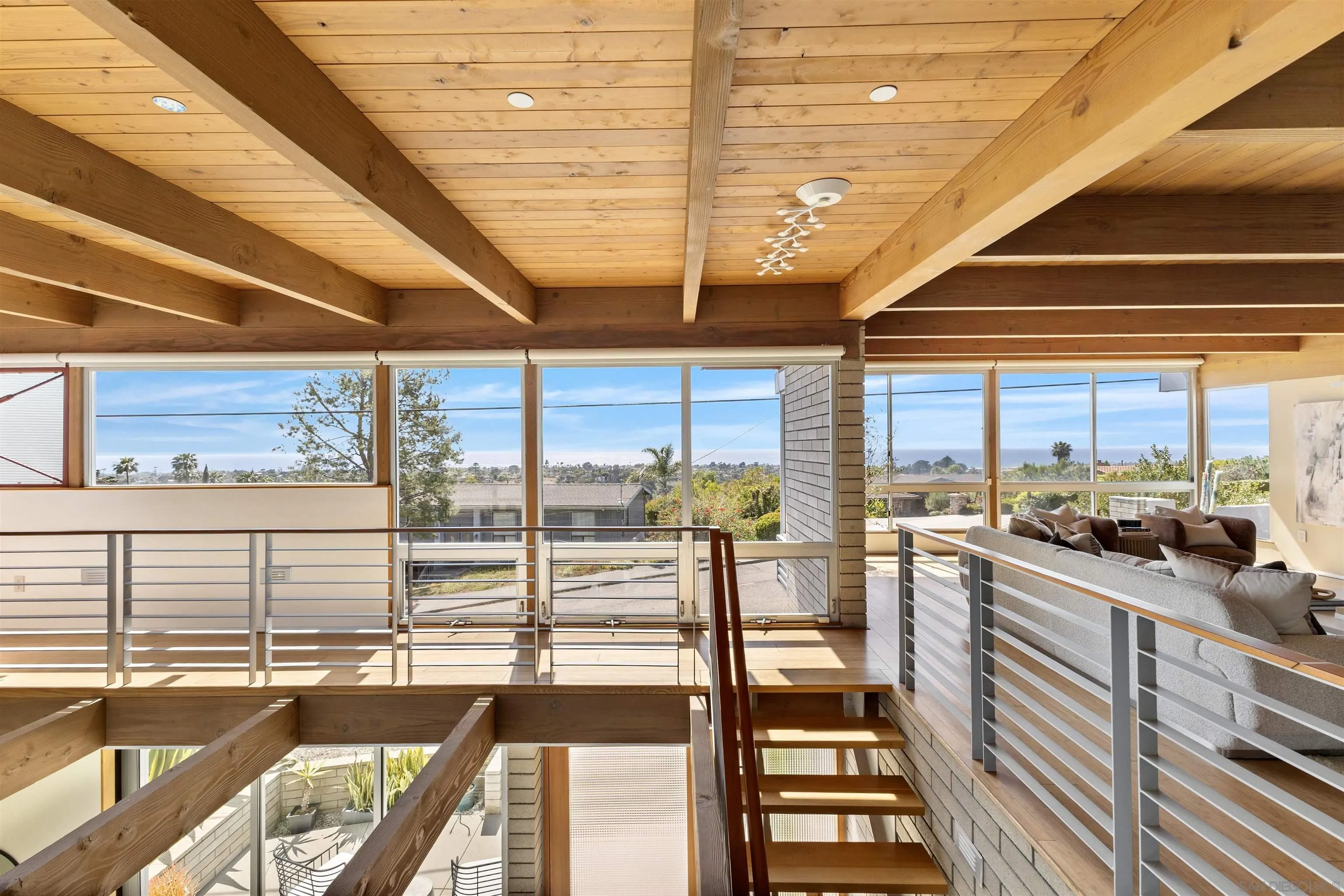 a view of a living room with large windows