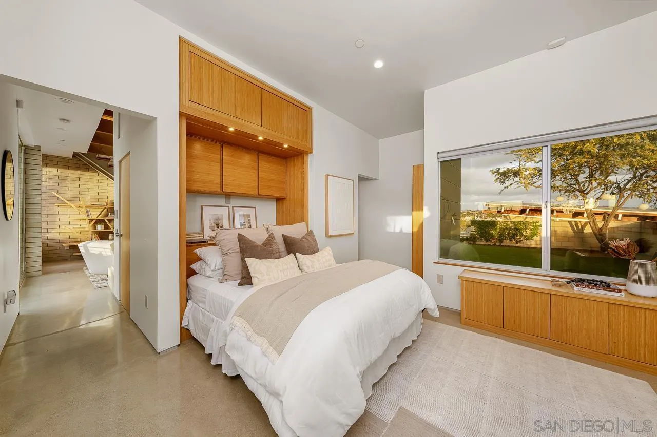 1635 Gascony Road Encinitas, CA 92024 - Photo 13 of 41 a bedroom with a bed and large windows