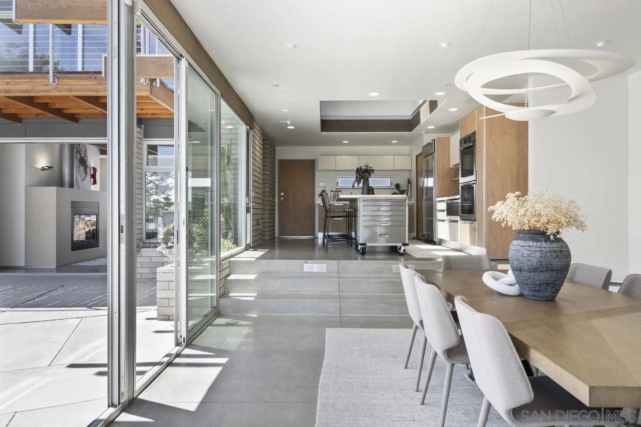 1635 Gascony Road Encinitas, CA 92024 - Photo 22 of 41 a dining room with furniture and a floor to ceiling window