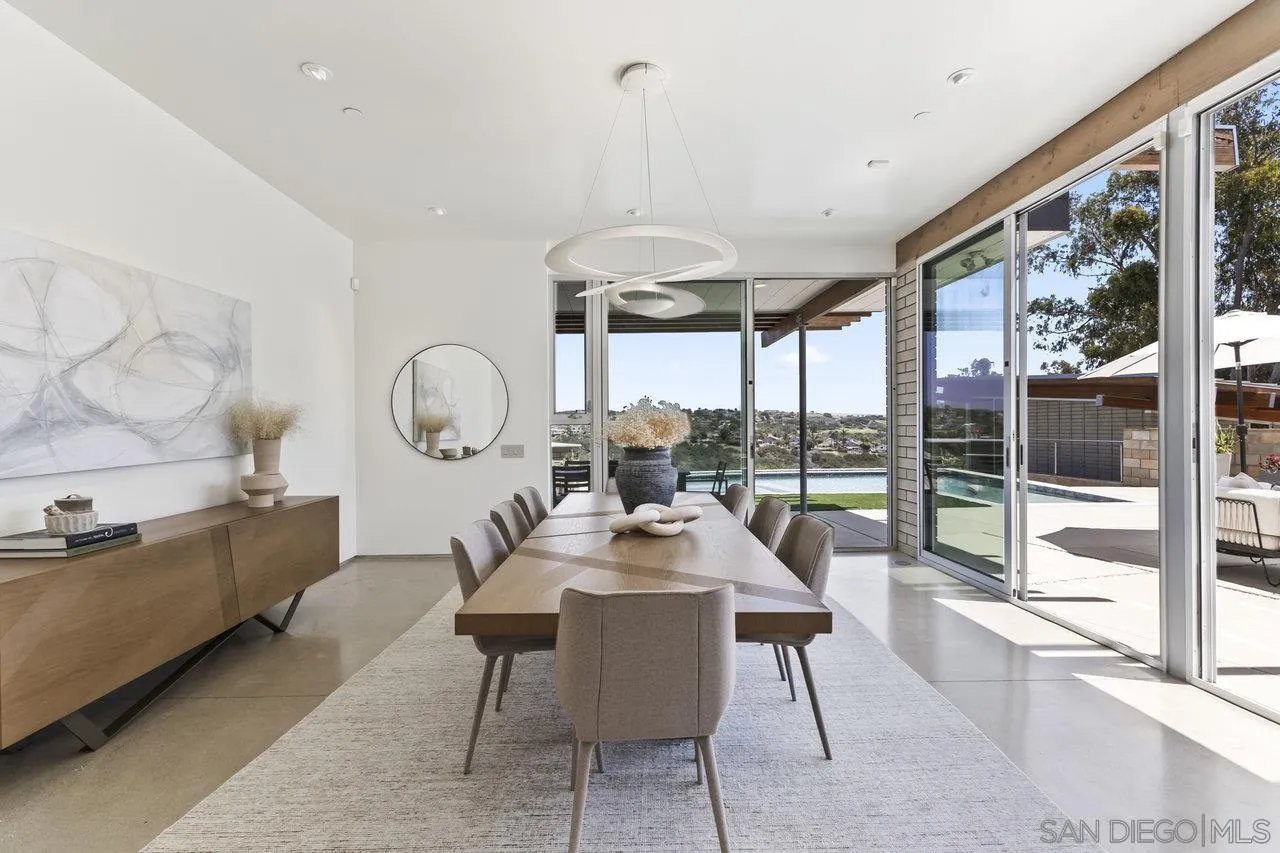 1635 Gascony Road Encinitas, CA 92024 - Photo 24 of 41 a dining room with wooden floor a glass table and chairs