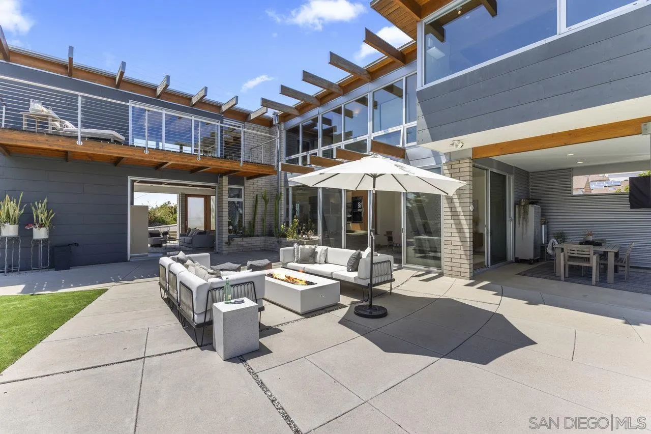 1635 Gascony Road Encinitas, CA 92024 - Photo 26 of 41 a view of a patio with a dining table and chairs under an umbrella