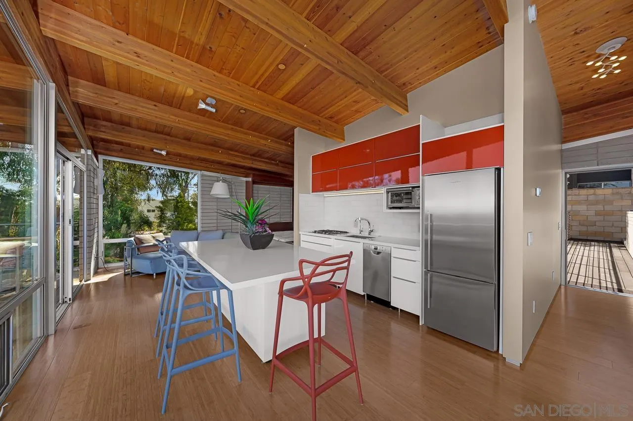 1635 Gascony Road Encinitas, CA 92024 - Photo 36 of 41 a kitchen with stainless steel appliances granite countertop a refrigerator a stove and a wooden floors