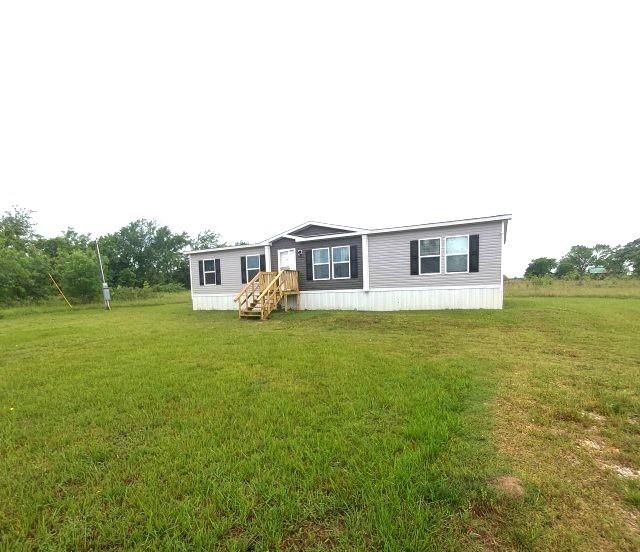 798 North 4190 Road Hugo, OK 74743 - Photo 1 of 16 a house view with a garden space