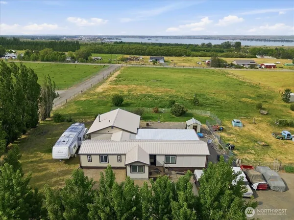 an aerial view of a house with a garden and lake view