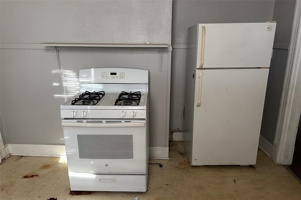 701 South Clements Street Gainesville, TX 76240 - Photo 11 of 28 a white refrigerator freezer sitting inside of a kitchen