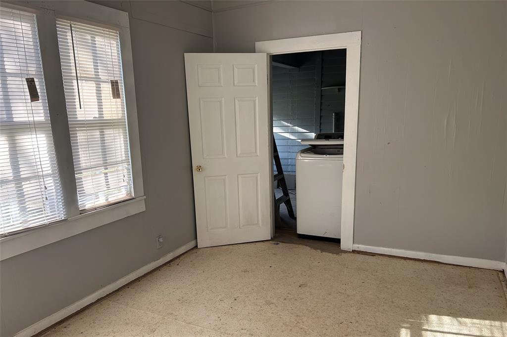 701 South Clements Street Gainesville, TX 76240 - Photo 16 of 28 an empty room with a window and a kitchen