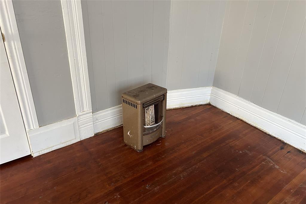 701 South Clements Street Gainesville, TX 76240 - Photo 18 of 28 a view of an empty room with wooden floor and a window