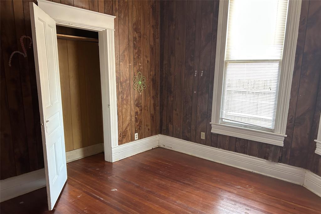 701 South Clements Street Gainesville, TX 76240 - Photo 25 of 28 a view of an empty room with wooden floor and a window
