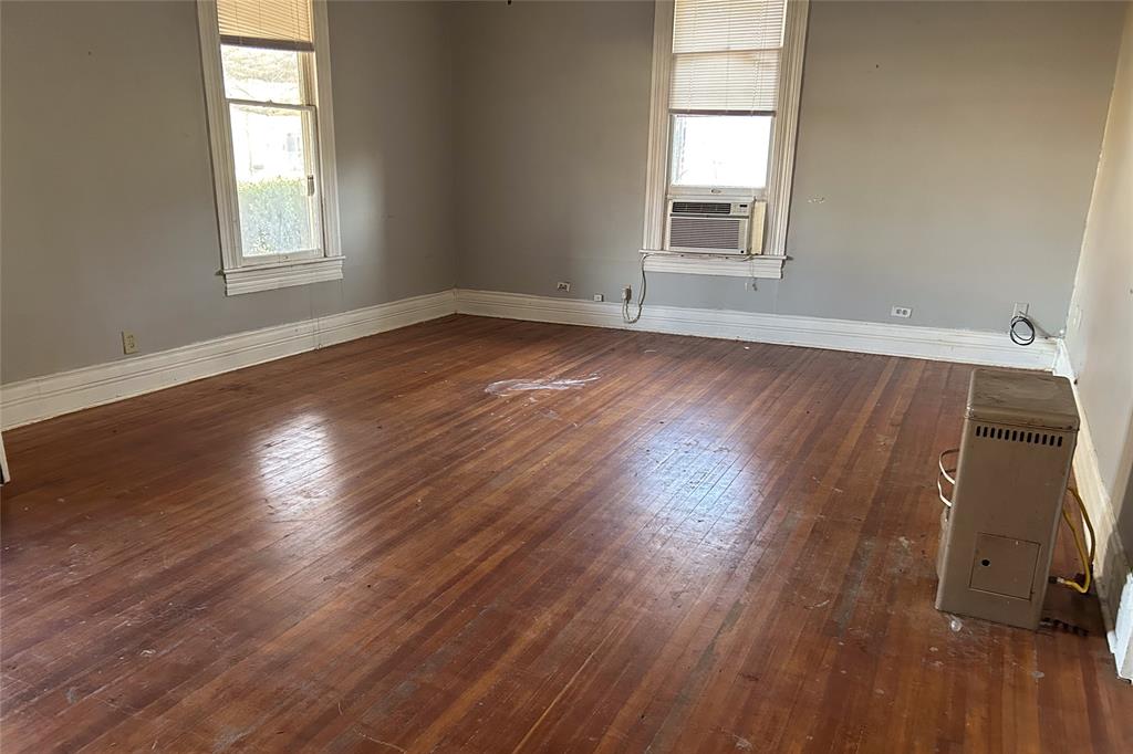 701 South Clements Street Gainesville, TX 76240 - Photo 28 of 28 a room with wooden floor and windows