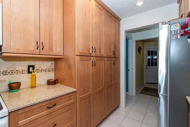 a kitchen with stainless steel appliances granite countertop wooden cabinets a sink and dishwasher
