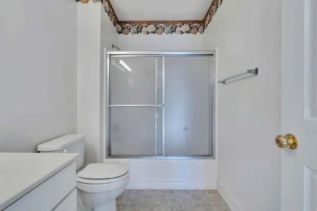 a bathroom with a toilet and a shower