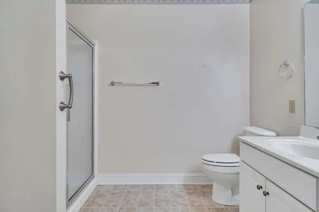 a white toilet sitting next to a bathroom sink