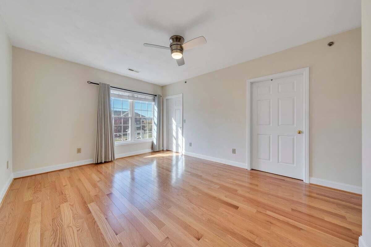 4444 Pheasant Ridge Road, Unit 207 Roanoke, VA 24014 - Photo 26 of 49 a view of an empty room with wooden floor and a window