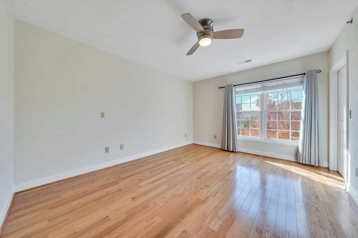 4444 Pheasant Ridge Road, Unit 207 Roanoke, VA 24014 - Photo 27 of 49 an empty room with wooden floor and windows