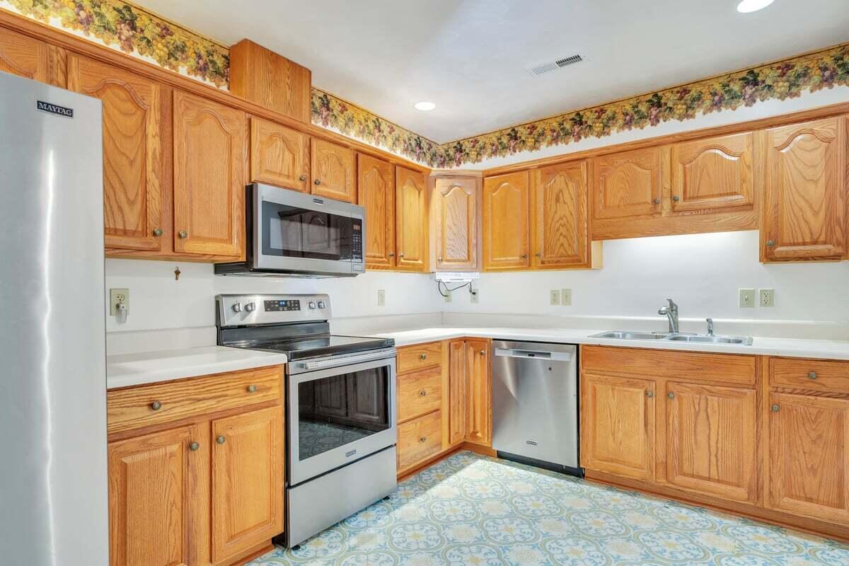 4444 Pheasant Ridge Road, Unit 207 Roanoke, VA 24014 - Photo 30 of 49 a kitchen with stainless steel appliances granite countertop a sink a stove a microwave and cabinets