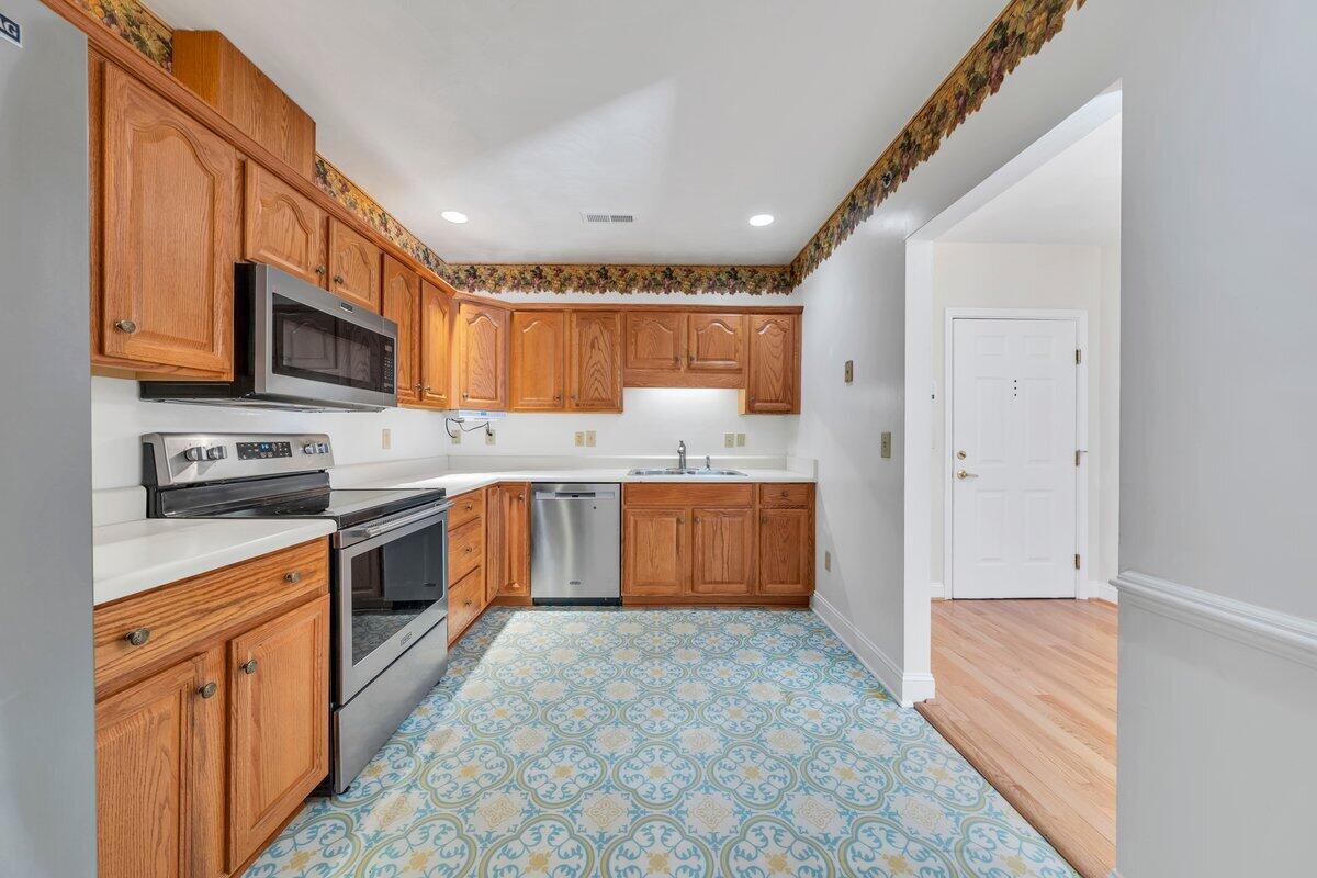 4444 Pheasant Ridge Road, Unit 207 Roanoke, VA 24014 - Photo 31 of 49 a kitchen with stainless steel appliances granite countertop a stove refrigerator sink and cabinets