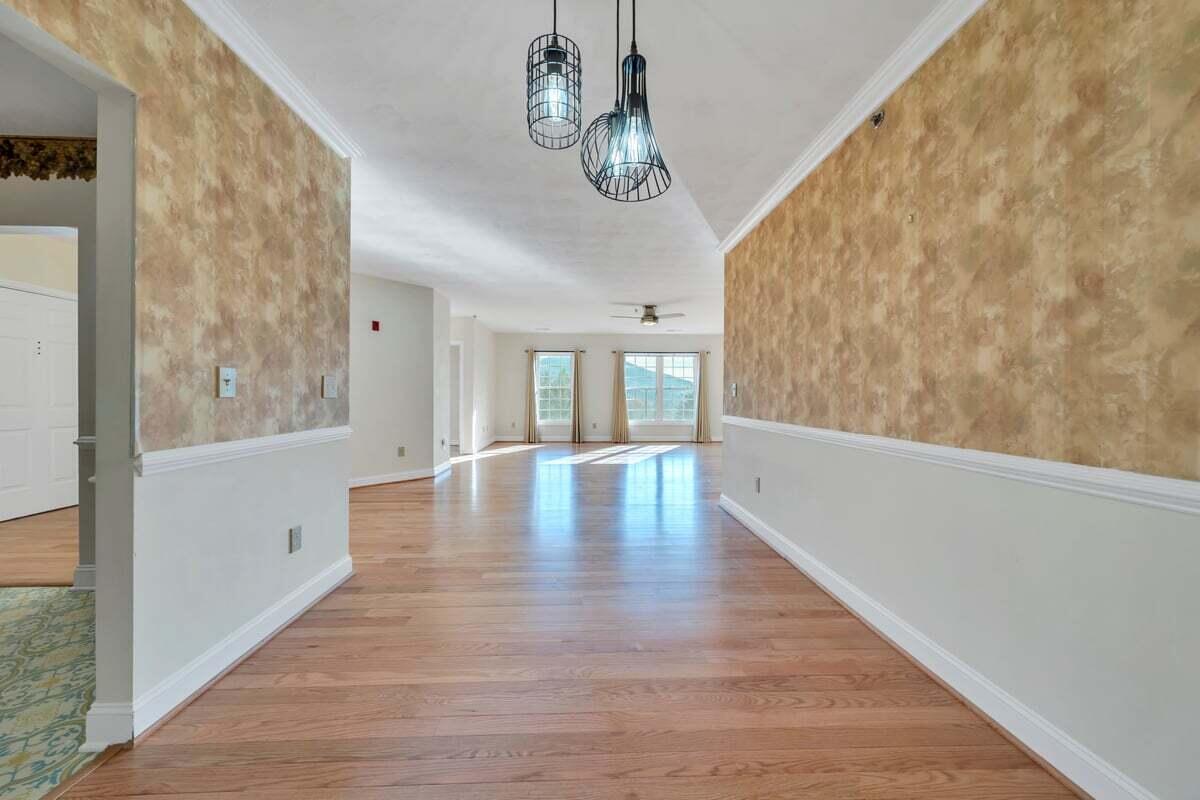 4444 Pheasant Ridge Road, Unit 207 Roanoke, VA 24014 - Photo 33 of 49 a view of an empty room with wooden floor and a window