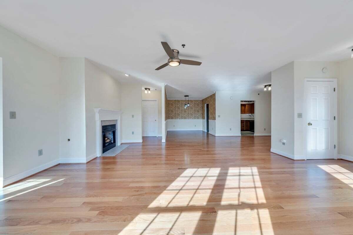 4444 Pheasant Ridge Road, Unit 207 Roanoke, VA 24014 - Photo 36 of 49 a view of empty room with wooden floor and fireplace