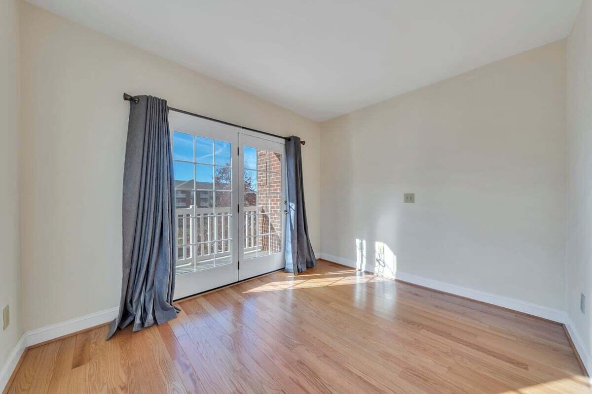4444 Pheasant Ridge Road, Unit 207 Roanoke, VA 24014 - Photo 40 of 49 an empty room with wooden floor and windows