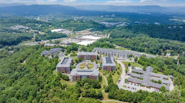 an aerial view of a house with a yard and lake view
