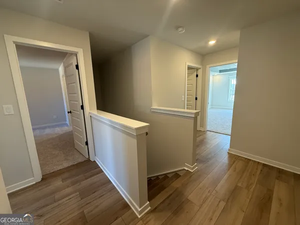 a view of hallway with wooden floor