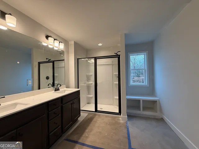 a bathroom with a granite countertop toilet sink and shower