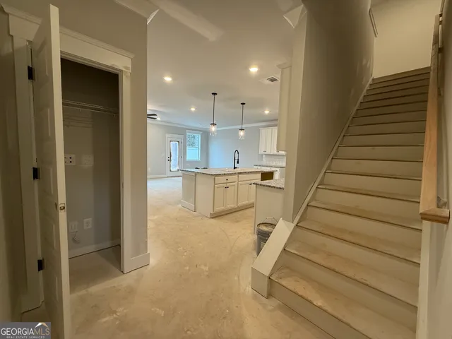 a view of entryway and hall with wooden floor