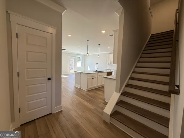 a view of a kitchen with wooden floor and electronic appliances