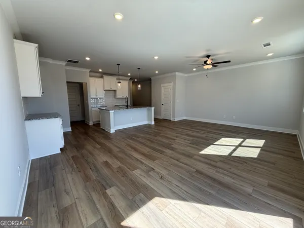 a view of kitchen and hall with wooden floor