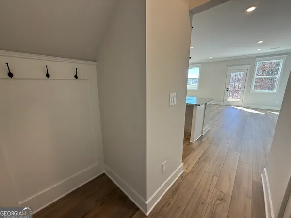 a view of a room with wooden floor