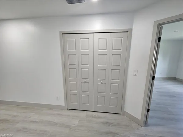 an empty room with wooden floor