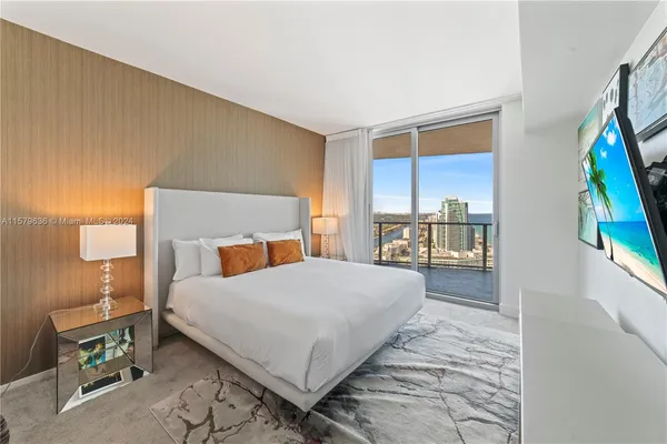 a bedroom with a bed and a large window