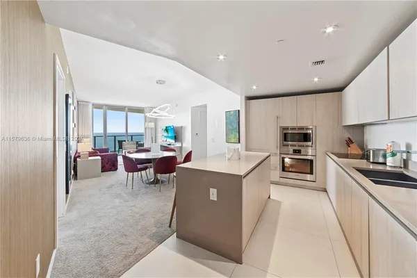 a kitchen with counter top space a sink and appliances