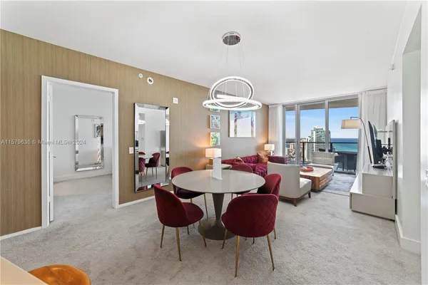 a view of a livingroom with furniture and a dining table