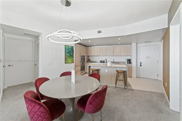 a dining room with furniture and wooden floor