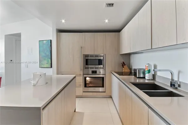 a kitchen that has a sink and a stove in it