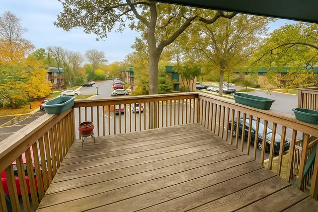 a view of balcony with wooden floor and fence