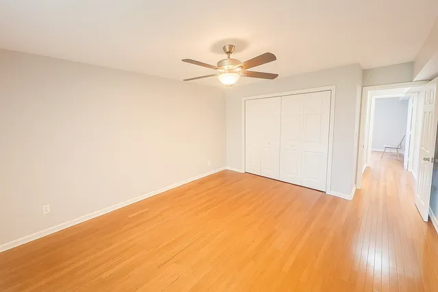 a view of empty room with wooden floor