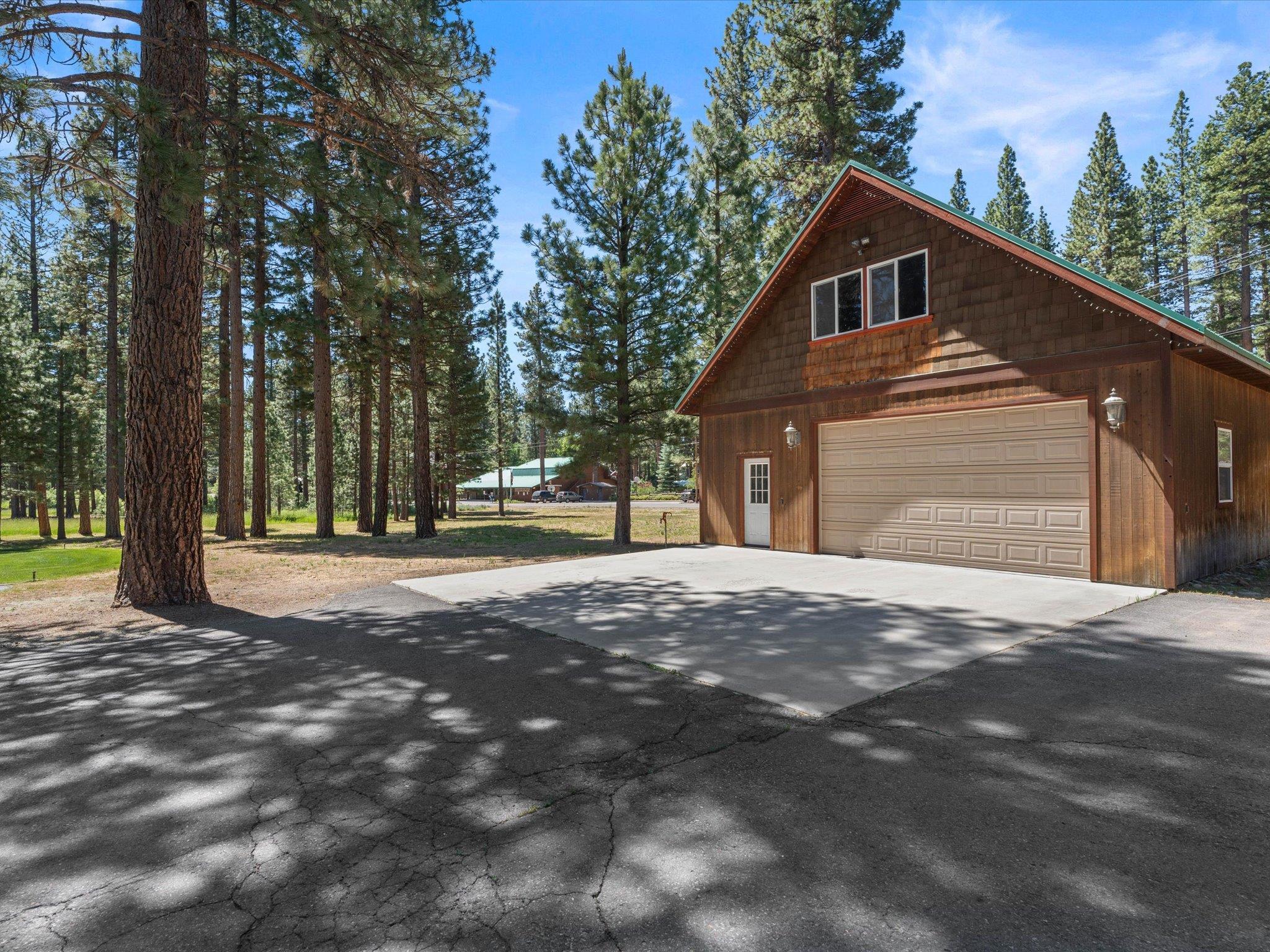 97 Main Street Calpine, CA 96124 - Photo 8 of 43 a front view of a house with a yard and garage