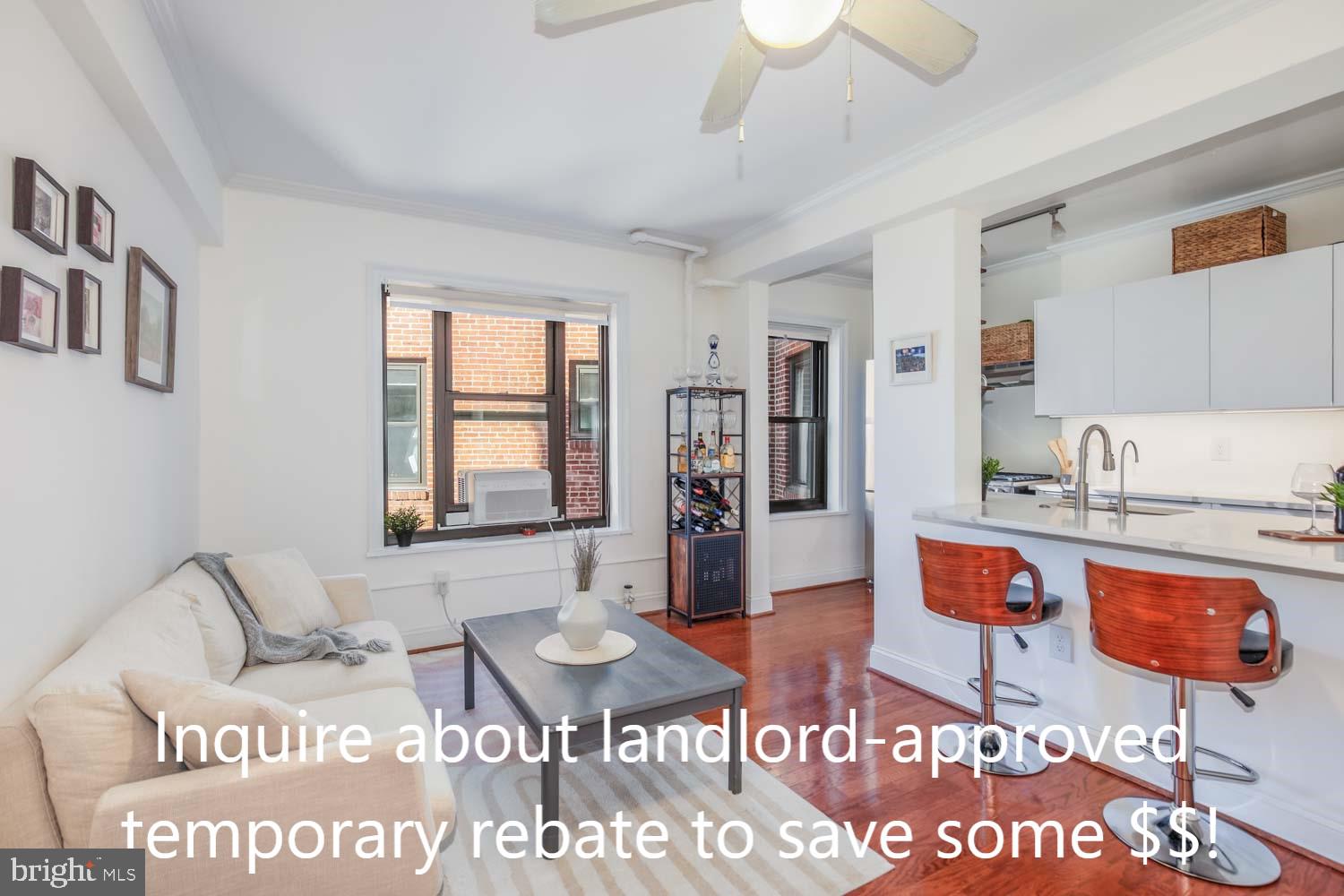 a living room with furniture a flat screen tv and a table