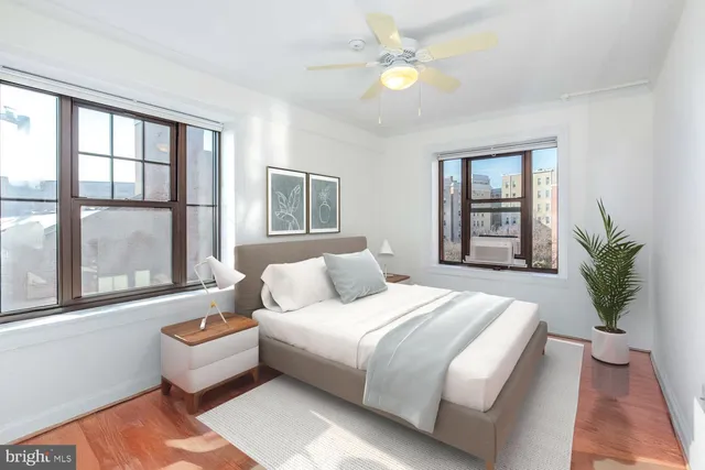 a bedroom with a large bed couch and a window